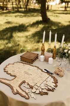 a table topped with a board game and candles