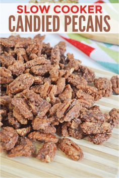 a pile of slow cooker candied pecans sitting on top of a cutting board