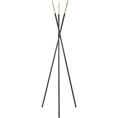 a black and white floor lamp with three wooden sticks