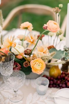 the table is set with flowers and candles