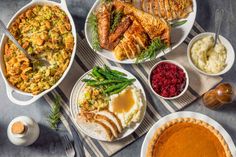 a table topped with lots of different types of food and dishes filled with sauces