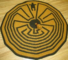 a yellow and black crocheted rug on the floor