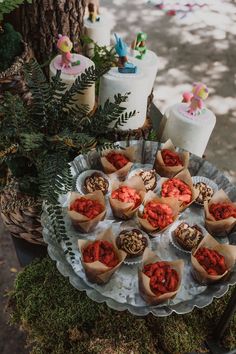 a platter filled with lots of food sitting on top of a table next to a tree