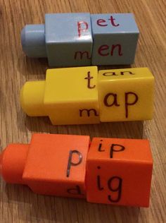 three erasers with words written on them sitting on a wooden table next to each other