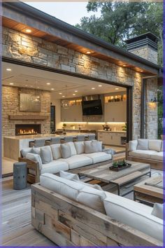 an outdoor living area with couches and tables