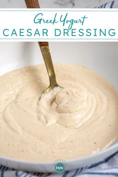 a spoon in a white bowl filled with cream cheese dressing and text overlay reads greek yogurt caesar dressing