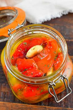 a jar filled with tomato sauce on top of a wooden table