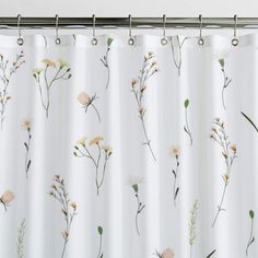 a white shower curtain with flowers on it