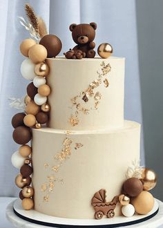 a three tiered cake decorated with teddy bears and other decorative items on it's side