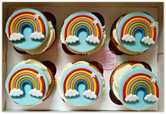 cupcakes with rainbow frosting in a box