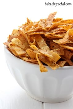 a white bowl filled with baked potato chips