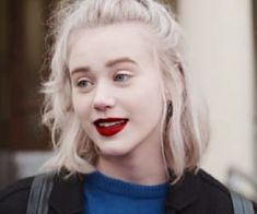 a woman with blonde hair and red lipstick