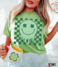 Time to show your Irish pride with this amazing retro St Patrick's Day T-shirt! Featuring a bold design with a retro smiley face on a checkered background, this St Patricks Day tee is perfect for any fan of the holiday. Be the most festively dressed at the Paddy pub crawl and family gatherings! 🍀  Comfort Colors® Lucky Vibes T-shirt, St Patricks Retro Smiley, St Patricks Day T-shirt, Retro Lucky Smile Faces T-shirt, Patrick Day T-shirt SIZE UP for an OVERSIZED FIT (see size chart in listing pho Green Retro Graphic Design Top, St. Patrick's Day Graphic T-shirt, St. Patrick's Day Graphic Tee With Graphic Print, St. Patrick's Day Graphic Tee With Print, St. Patrick's Day Graphic Tee, Retro Green T-shirt For Fan Merchandise, Retro Green T-shirt For Fans, Green Fun T-shirt With Screen Print, Fun Green T-shirt With Graphic Print