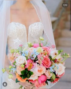 a bride holding a bouquet of flowers in her hands