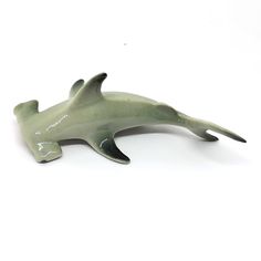 a ceramic dolphin figurine on a white background