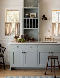 an image of a kitchen with blue cabinets and white counter tops on instagrams