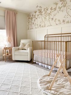 a baby's room with a crib and chair