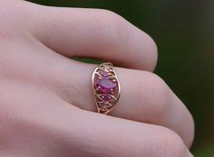 14K Rose Gold Ruby three stone ring. This ring is set with three genuine Rubies. The Rubies are a bright red color and they combine to a total weight of 0,68 carat. This ring is 14KT Rose Gold, weighs 2.5 grams and is a finger size 7, can be resized (please inquire about sizing with the finger size you need). Red 14k Rose Gold Rings For Anniversary, Red Ruby Ring In 14k Rose Gold, Ruby Ring In 14k Rose Gold With Round Shape, Red 14k Rose Gold Jewelry For Anniversary, Elegant Red Three Stone Birthstone Ring, Elegant Red Three-stone Birthstone Ring, Pink Gold Ruby Ring, Oval Pink Gold Ruby Ring Fine Jewelry, Oval Pink Gold Ruby Ring, Fine Jewelry Style