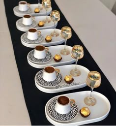 there are many cups and saucers on the table ready to be served with tea or coffee