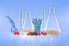 several beakles filled with different types of food and vegetables next to each other on a blue background