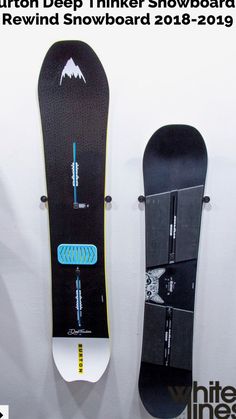 two snowboards are hanging on the wall next to each other, one is upside down