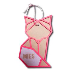 an ornament shaped like a cat with the word mes on it's chest