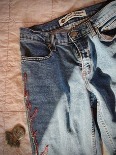 size 2, high waisted, straight leg denim jeans. hand embroidered by me! these vintage Harley's are in perfect condition.  i have a 25 inch waist & they fit me very well. note: these are pre-owned & may have some minor flaws, but i look for the best quality jeans. Fitted Embroidered Flare Jeans With Straight Leg, Floral Embroidered Straight Leg Jeans, Embroidered Mid-rise Fitted Jeans, Trendy Embroidered Straight Leg Pants, Mid-rise Embroidered Fitted Jeans, Fitted Mid-rise Embroidered Jeans, Embroidered Fitted Casual Jeans, Trendy Embroidered Mid-rise Jeans, Embroidered Straight Leg Denim Blue Jeans