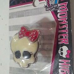 a white and red skull with a bow on it's head in a package