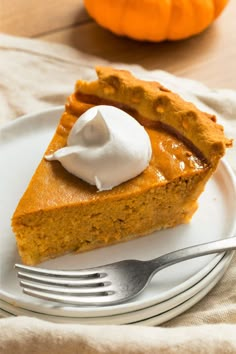 a slice of pumpkin pie with whipped cream on top