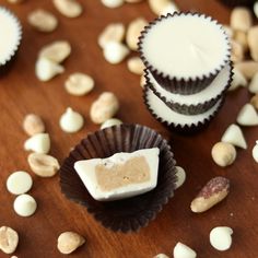 several cupcakes with peanut butter and white chocolate frosting on a wooden table