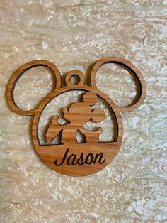 a wooden mickey mouse ornament with the name mason on it