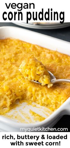 a close up of a spoon in a casserole dish with corn pudding on it