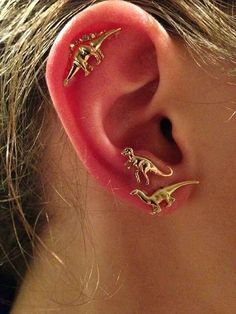 an ear with three small dinosaurs attached to it