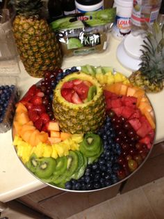 a platter filled with lots of different types of fruit on top of a counter