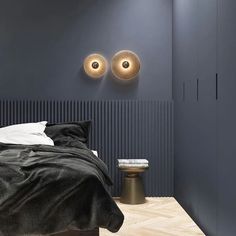 a bed with two lights on the wall above it