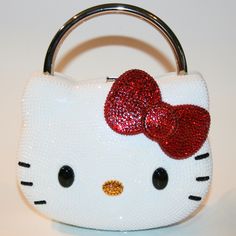 a hello kitty purse with sequins and a red bow on the top,