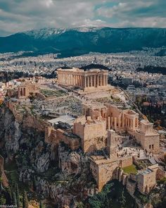 an aerial view of the acrobatic city of rome, with mountains in the background