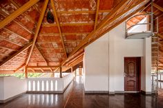 an empty room with wood floors and wooden ceiling