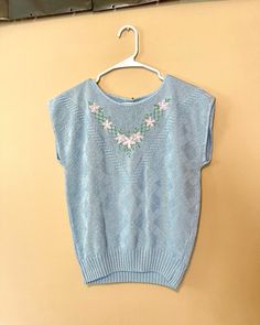 Blue Sleeveless Sweater For Spring, Blue Knit Sweater Vest For Spring, Blue Knit Vest For Spring, Fitted Knit Tops With Floral Embroidery, Fitted Floral Embroidery Knit Tops, Fitted Blue Sweater Vest For Spring, Blue Fitted Sweater Vest For Spring, Blue Knitted Vest, 80s Sweater Vest