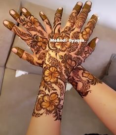 the hands are decorated with henna and flowers