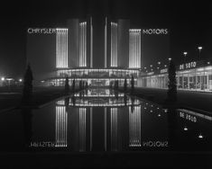 black and white photograph of the chrysler building at night with its reflection in the water