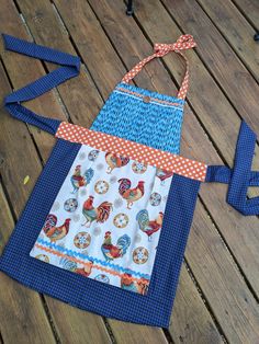 an apron made out of fabric sitting on top of a wooden floor