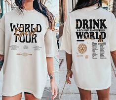 a woman walking down the street wearing a t - shirt that says weird tour around the world