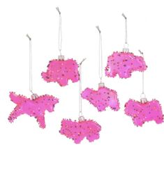 six pink ornaments hanging from strings on a white background, each with different shapes and sizes