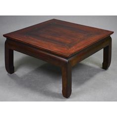 a square wooden table with two legs