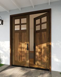 two wooden doors are open in front of a house