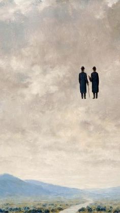 two people standing on top of a hill under a cloudy sky