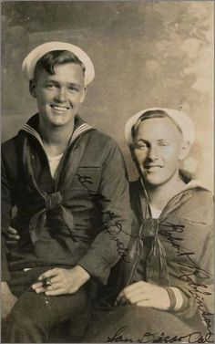 an old black and white photo of two men in sailor's outfits, one wearing a hat