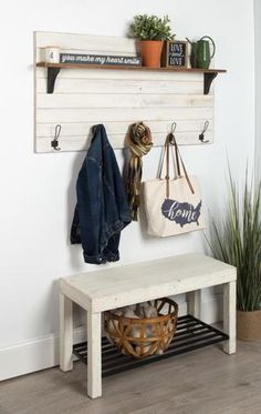 a white bench sitting next to a wooden shelf