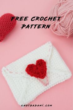 a crocheted heart on top of a white envelope